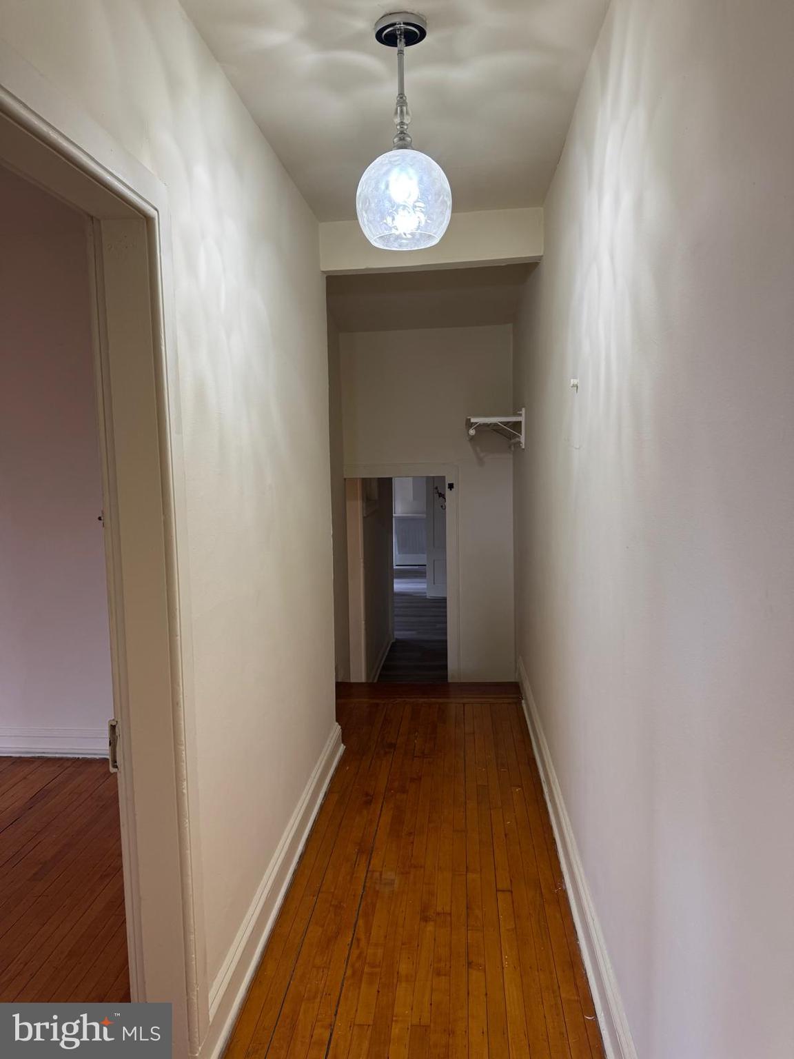 230 West Lafayette Avenue, Unit 3 Baltimore, MD 21217 - Photo 10 of 19 a view of a hallway with a chandelier