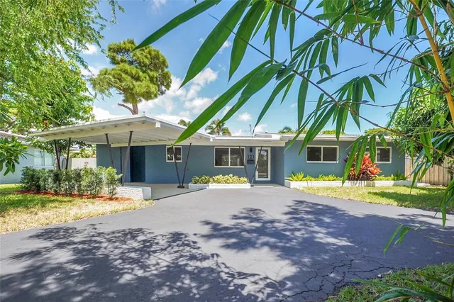 a view of a house with a yard and sitting area