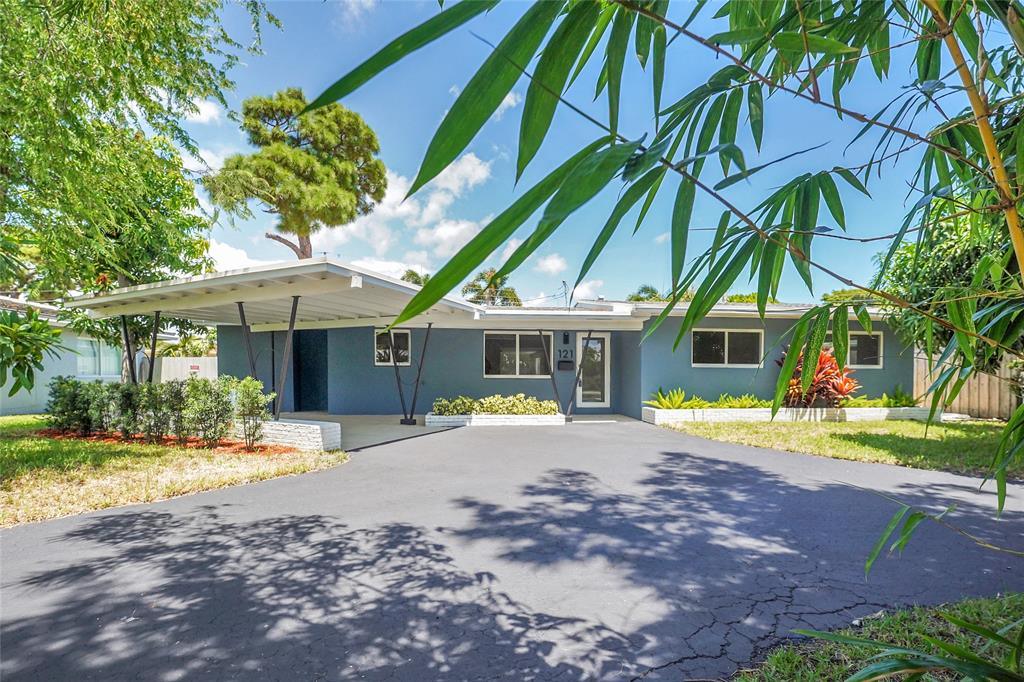 a view of a house with a yard and sitting area