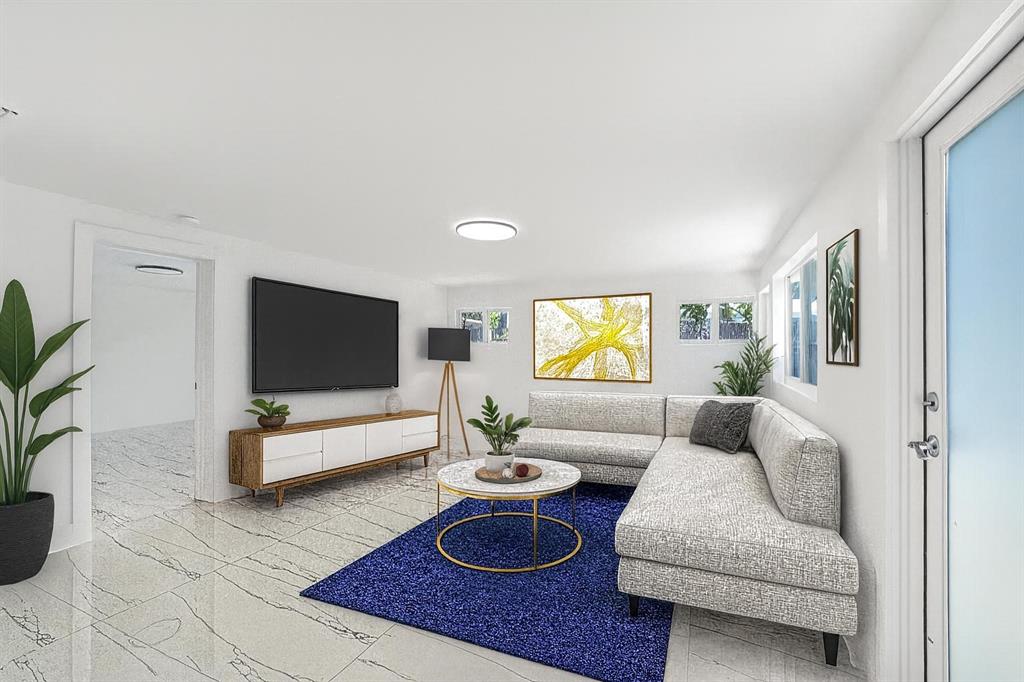 121 Southeast 8th Street Pompano Beach, FL 33060 - Photo 14 of 14 a living room with furniture and a flat screen tv