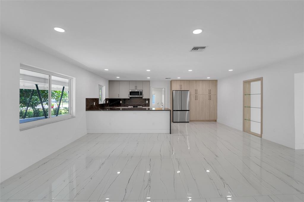 121 Southeast 8th Street Pompano Beach, FL 33060 - Photo 2 of 14 a view of kitchen with stainless steel appliances refrigerator oven and cabinets