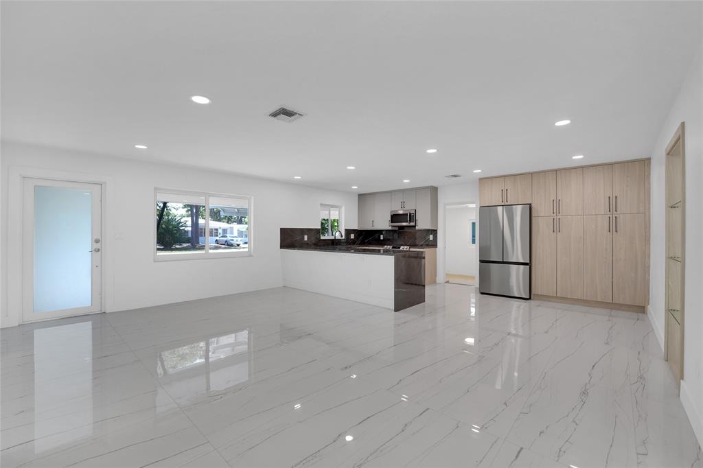 121 Southeast 8th Street Pompano Beach, FL 33060 - Photo 5 of 14 a view of a kitchen with a sink and a refrigerator
