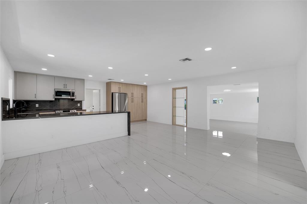121 Southeast 8th Street Pompano Beach, FL 33060 - Photo 6 of 14 a view of kitchen with refrigerator and window