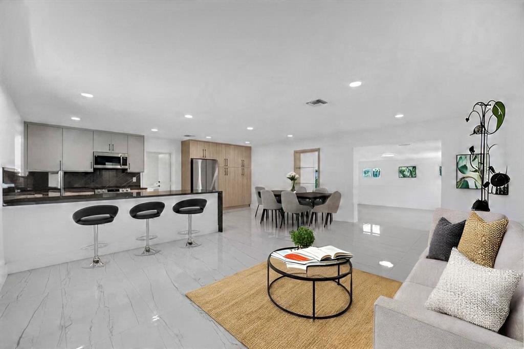 121 Southeast 8th Street Pompano Beach, FL 33060 - Photo 7 of 14 a living room with furniture and a table