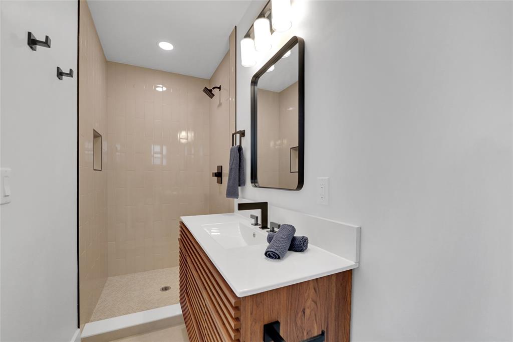 121 Southeast 8th Street Pompano Beach, FL 33060 - Photo 8 of 14 a bathroom with a sink a shower and a mirror