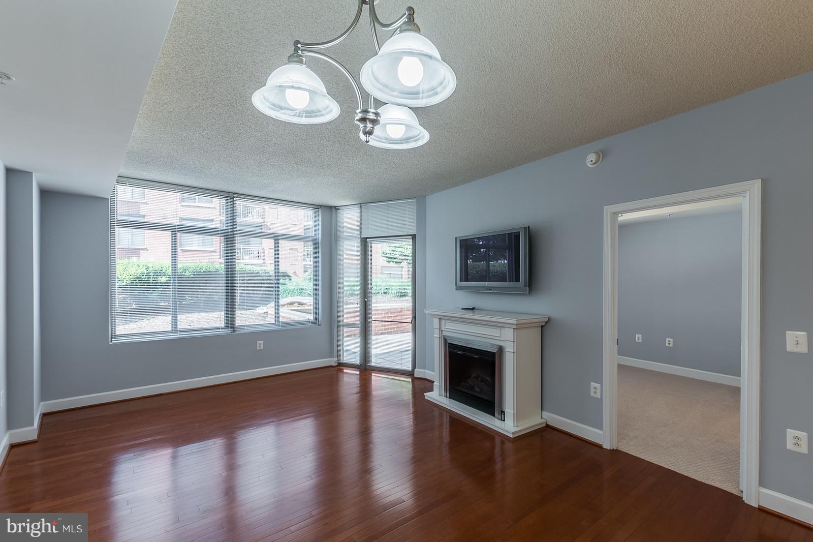 3600 South Glebe Road, Unit 227W Arlington, VA 22202 - Photo 12 of 29 a view of a livingroom with a fireplace wooden floor and windows