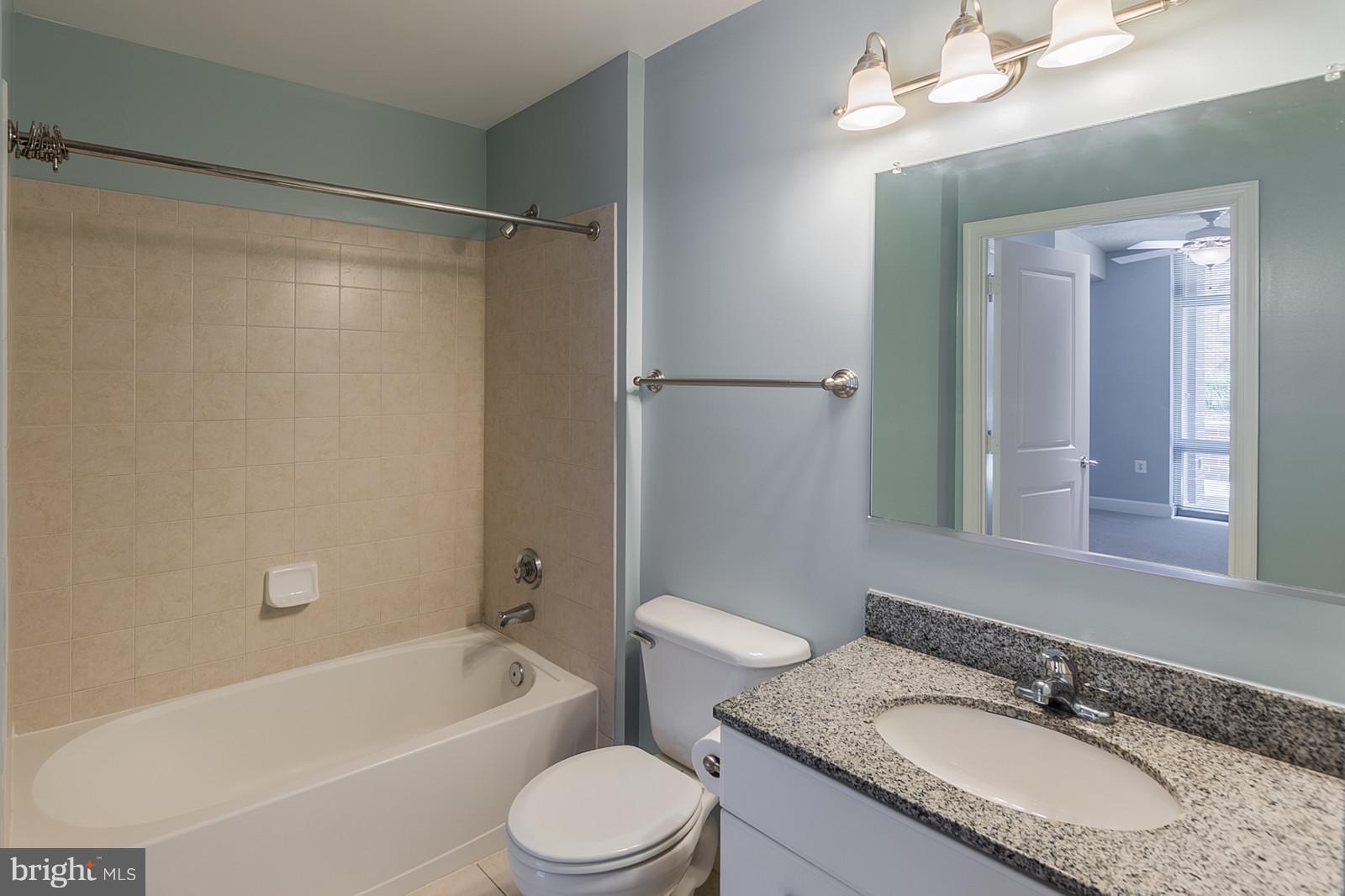 3600 South Glebe Road, Unit 227W Arlington, VA 22202 - Photo 17 of 29 a bathroom with a granite countertop sink toilet and shower