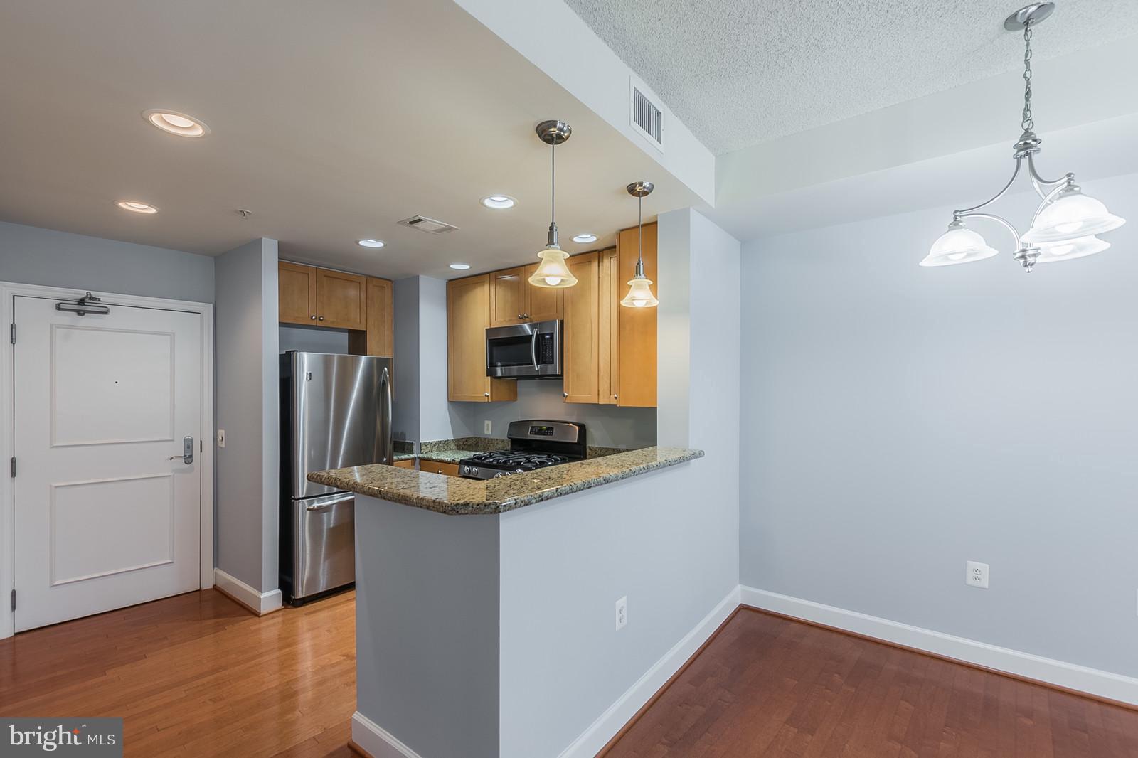 3600 South Glebe Road, Unit 227W Arlington, VA 22202 - Photo 5 of 29 a kitchen with stainless steel appliances granite countertop a refrigerator a sink and a stove