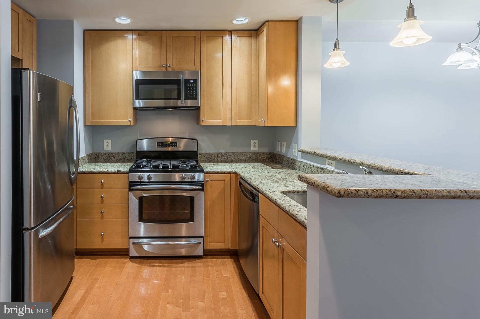 3600 South Glebe Road, Unit 227W Arlington, VA 22202 - Photo 6 of 29 a kitchen with stainless steel appliances granite countertop a stove a sink and a refrigerator