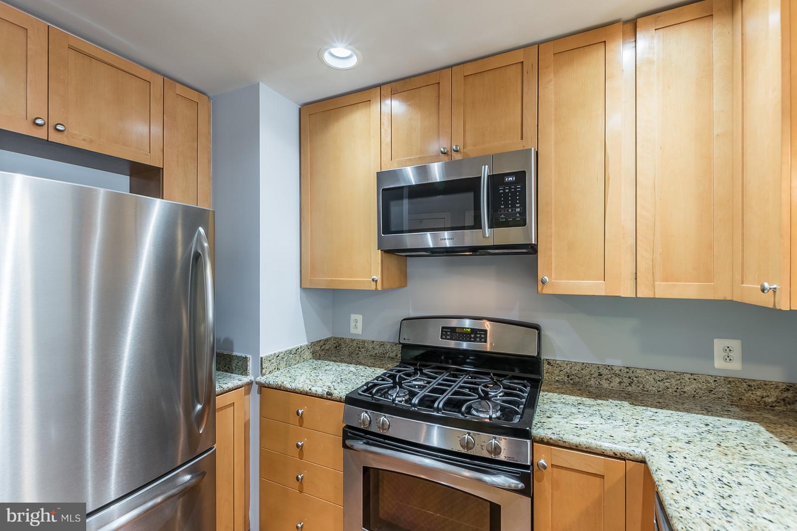 3600 South Glebe Road, Unit 227W Arlington, VA 22202 - Photo 7 of 29 a kitchen with granite countertop a refrigerator stove top oven and sink