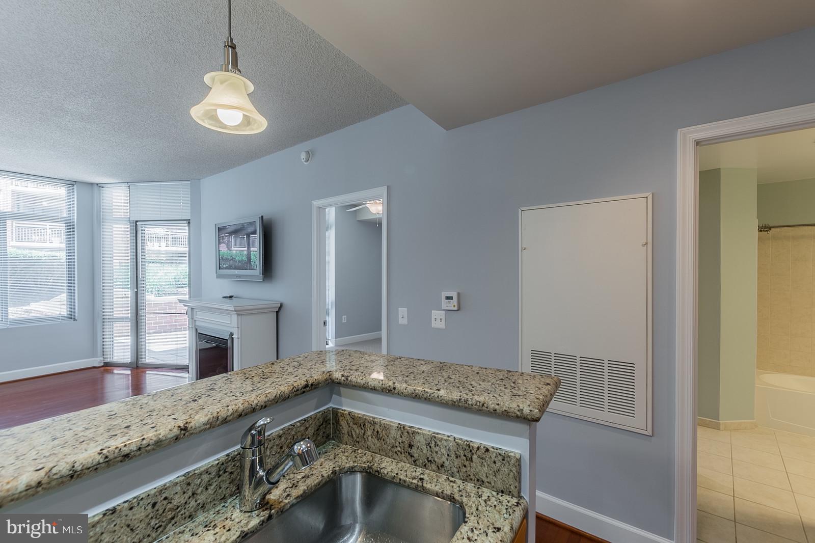 3600 South Glebe Road, Unit 227W Arlington, VA 22202 - Photo 9 of 29 a bathroom with a granite countertop sink and a mirror