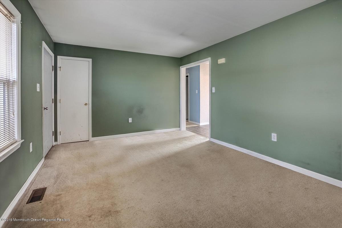 6 Bash Road Toms River, NJ 08753 - Photo 4 of 19 a view of an empty room with wooden floor and a window