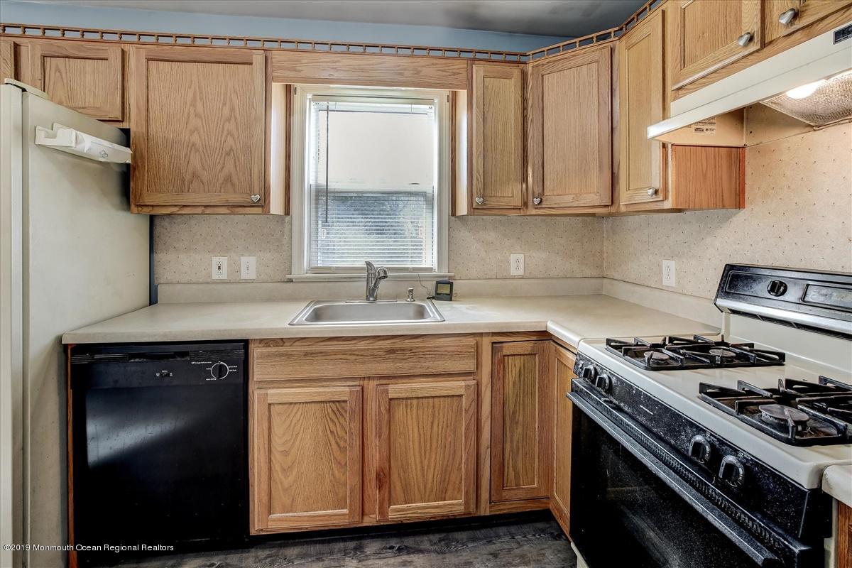 6 Bash Road Toms River, NJ 08753 - Photo 9 of 19 a kitchen with stainless steel appliances granite countertop a sink stove and cabinets