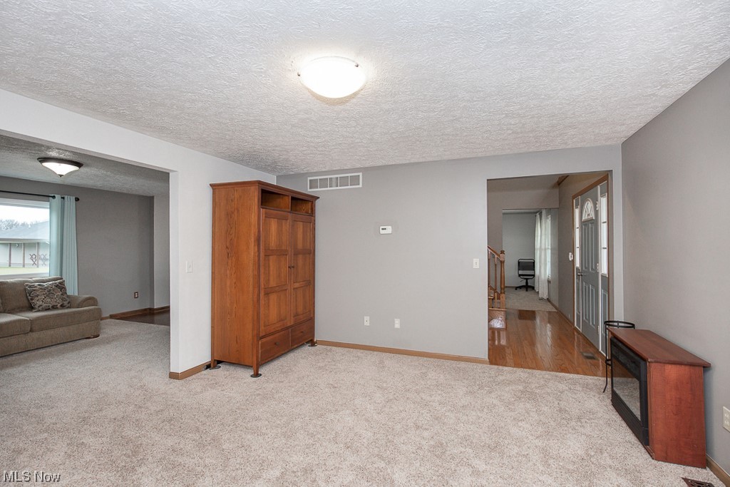 9708 Reed Road Grafton, OH 44044 - Photo 7 of 35 Formal Living Room with a textured ceiling and light carpet