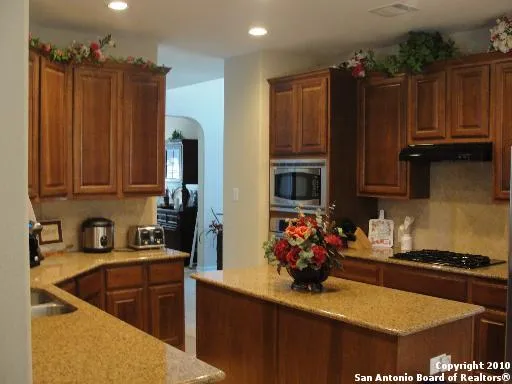 a kitchen with wooden cabinets and a sink