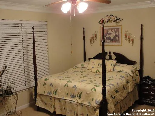 a bedroom with a bed and a night stand