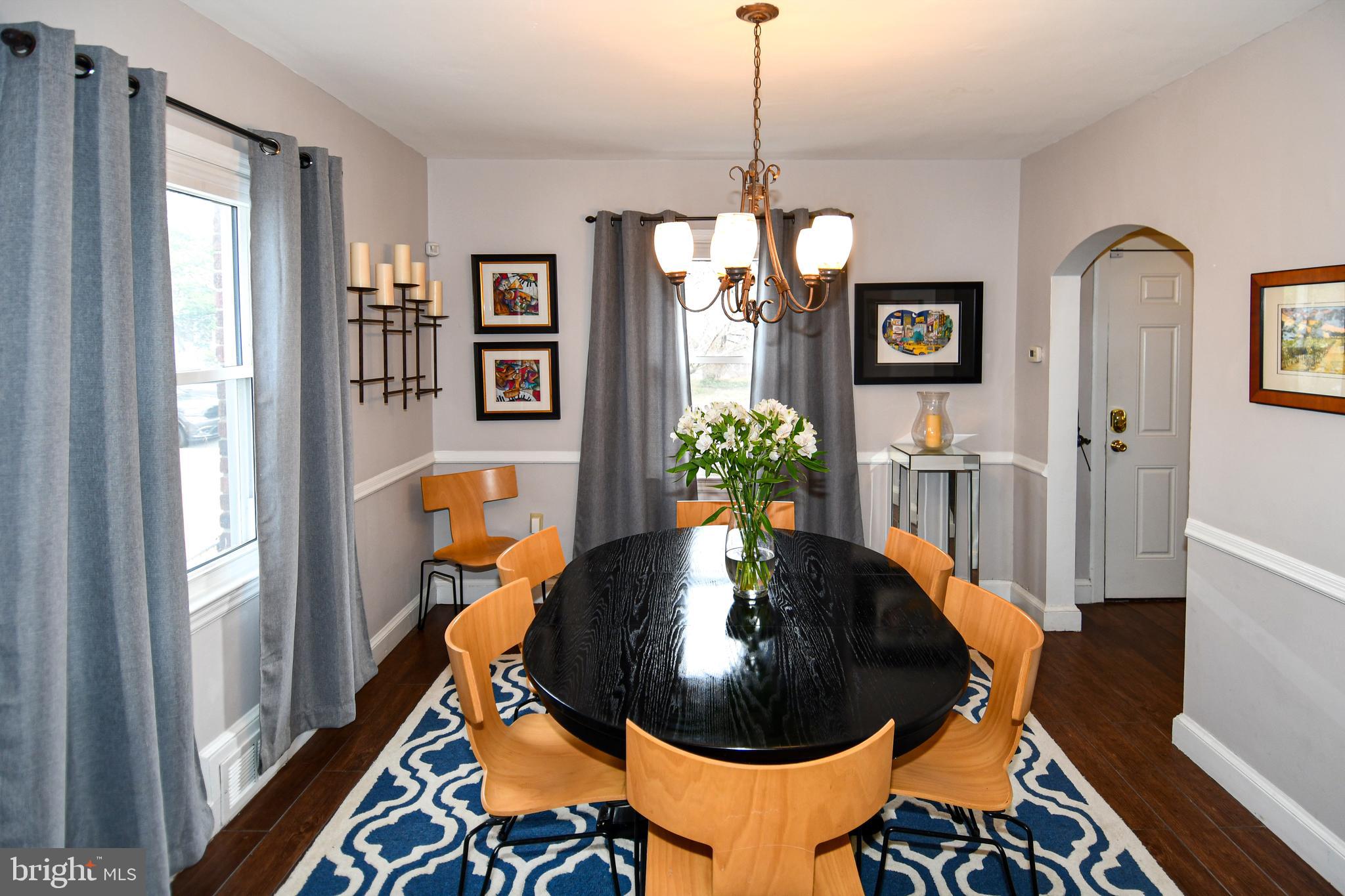 6208 Sligo Mill Road Northeast Washington, DC 20011 - Photo 19 of 50 a living room with furniture and a chandelier