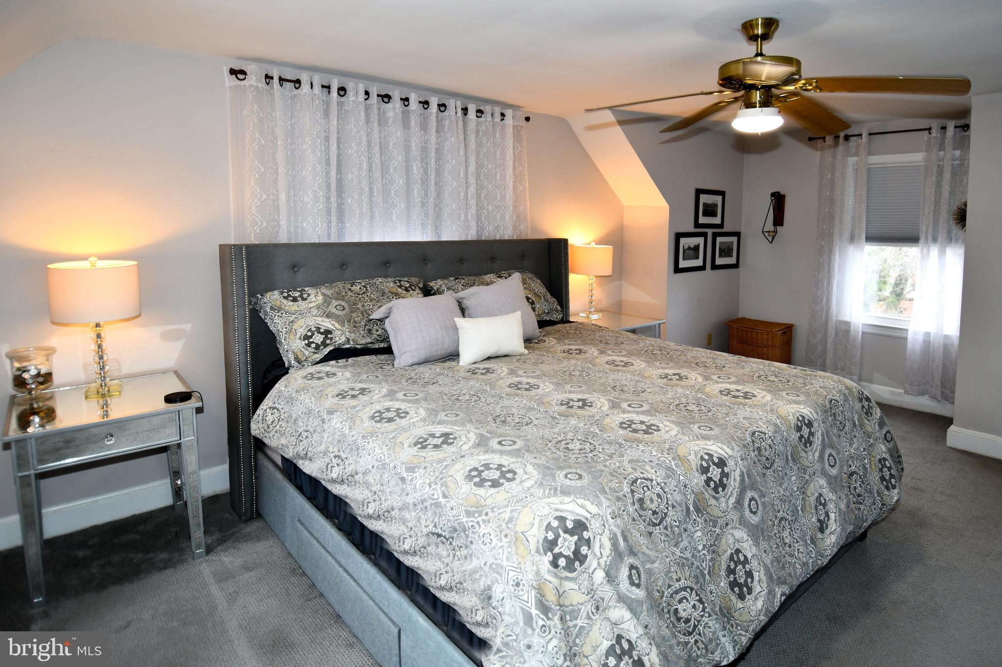 6208 Sligo Mill Road Northeast Washington, DC 20011 - Photo 28 of 50 a bedroom with a bed and a chandelier