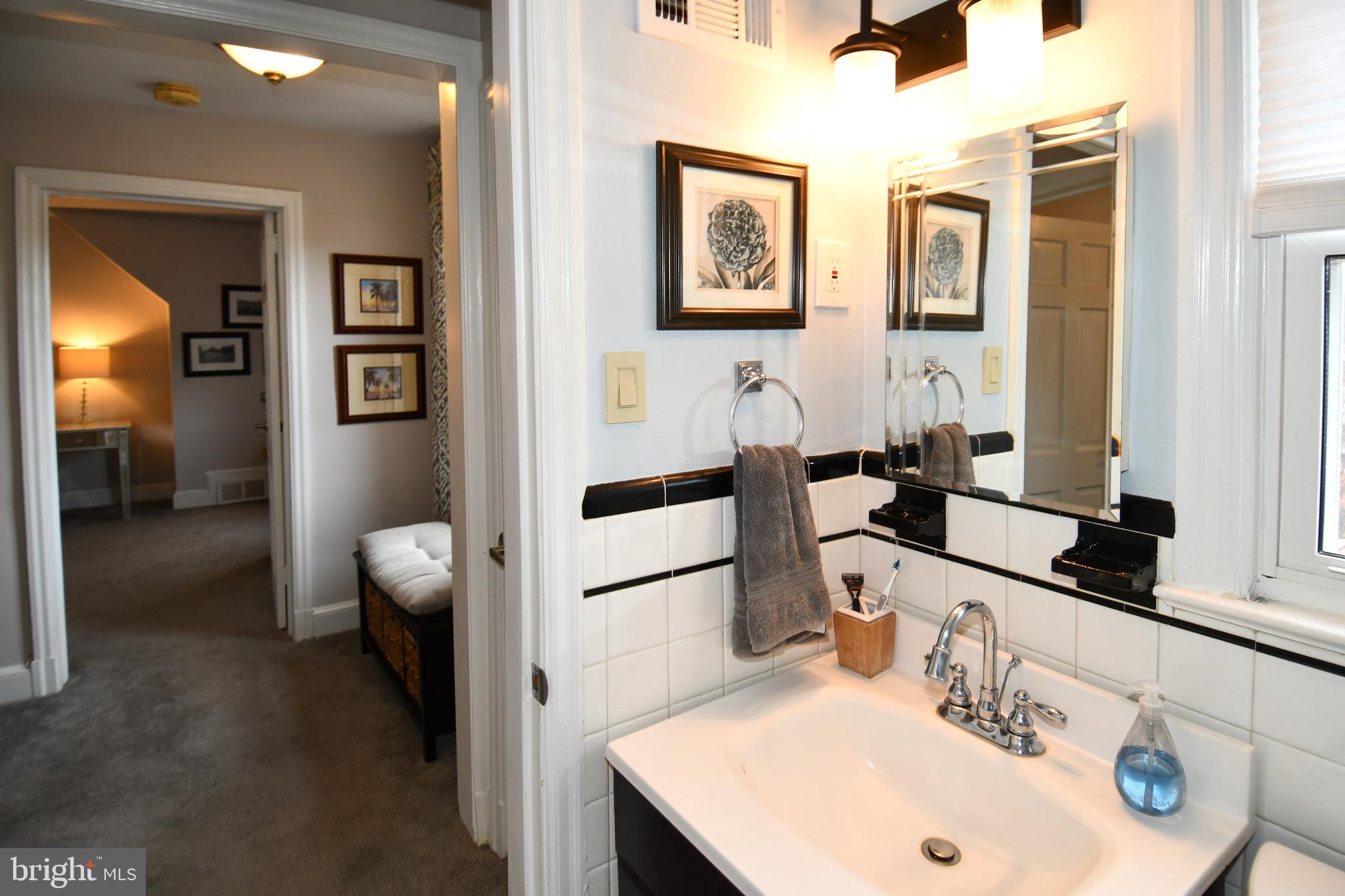 6208 Sligo Mill Road Northeast Washington, DC 20011 - Photo 33 of 50 a bathroom with a sink and a mirror
