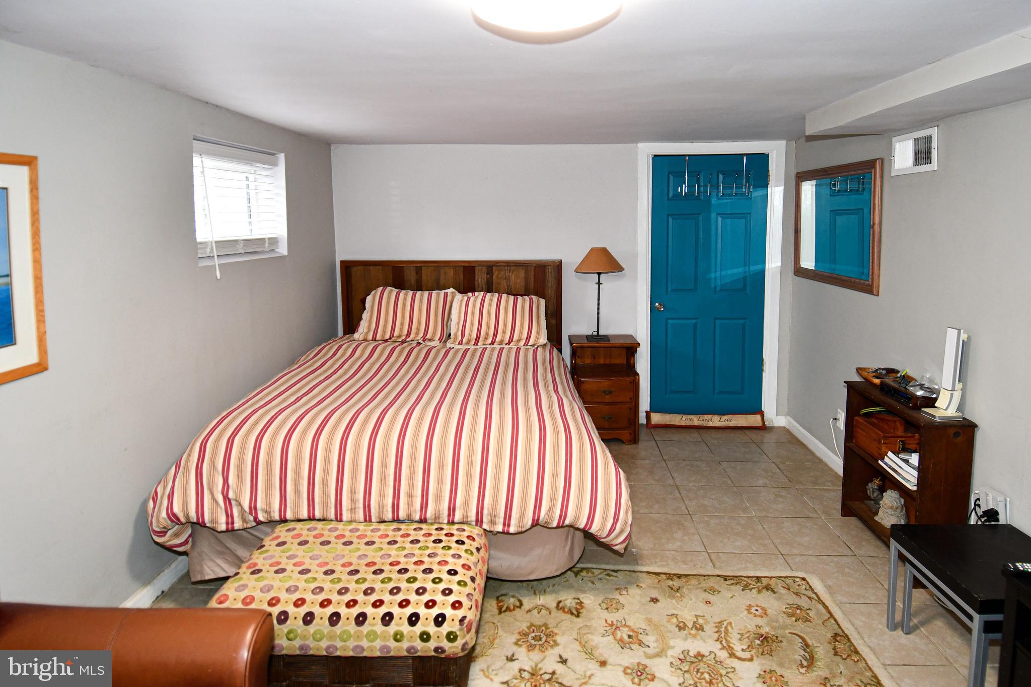 6208 Sligo Mill Road Northeast Washington, DC 20011 - Photo 35 of 50 a bedroom with a bed and wooden floor