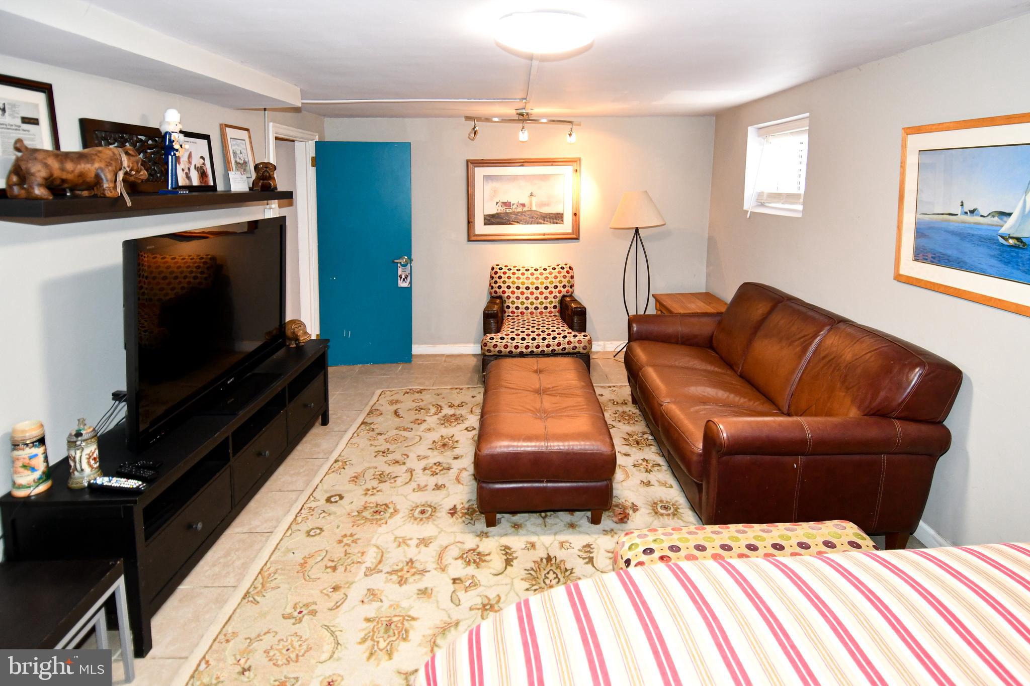 6208 Sligo Mill Road Northeast Washington, DC 20011 - Photo 37 of 50 a living room with furniture and a flat screen tv