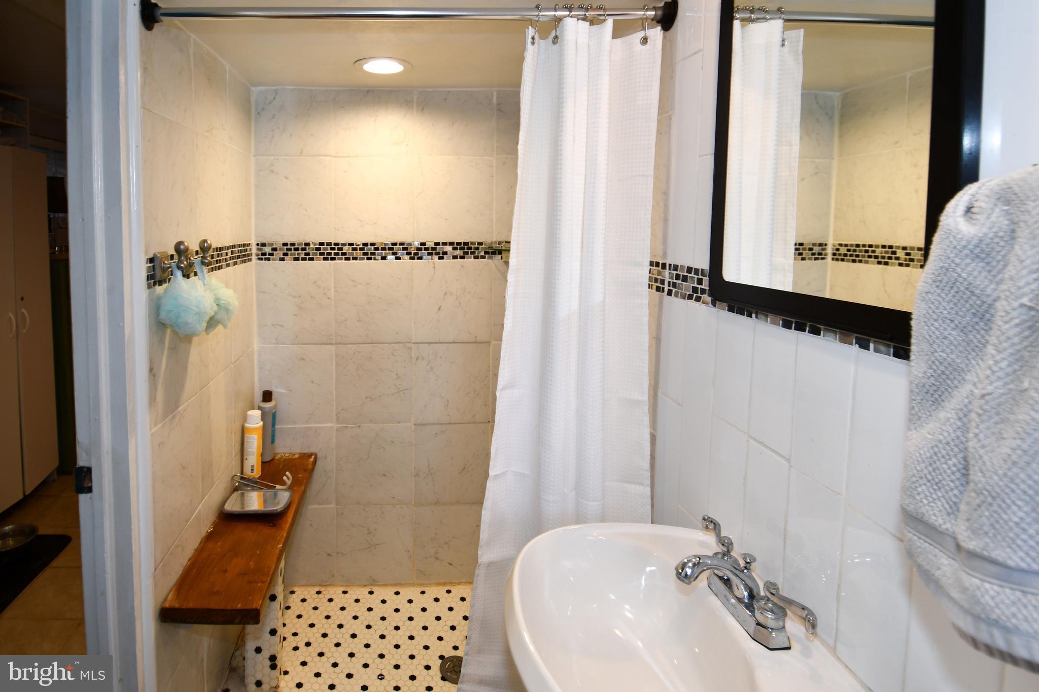 6208 Sligo Mill Road Northeast Washington, DC 20011 - Photo 39 of 50 a bathroom with a sink and a mirror