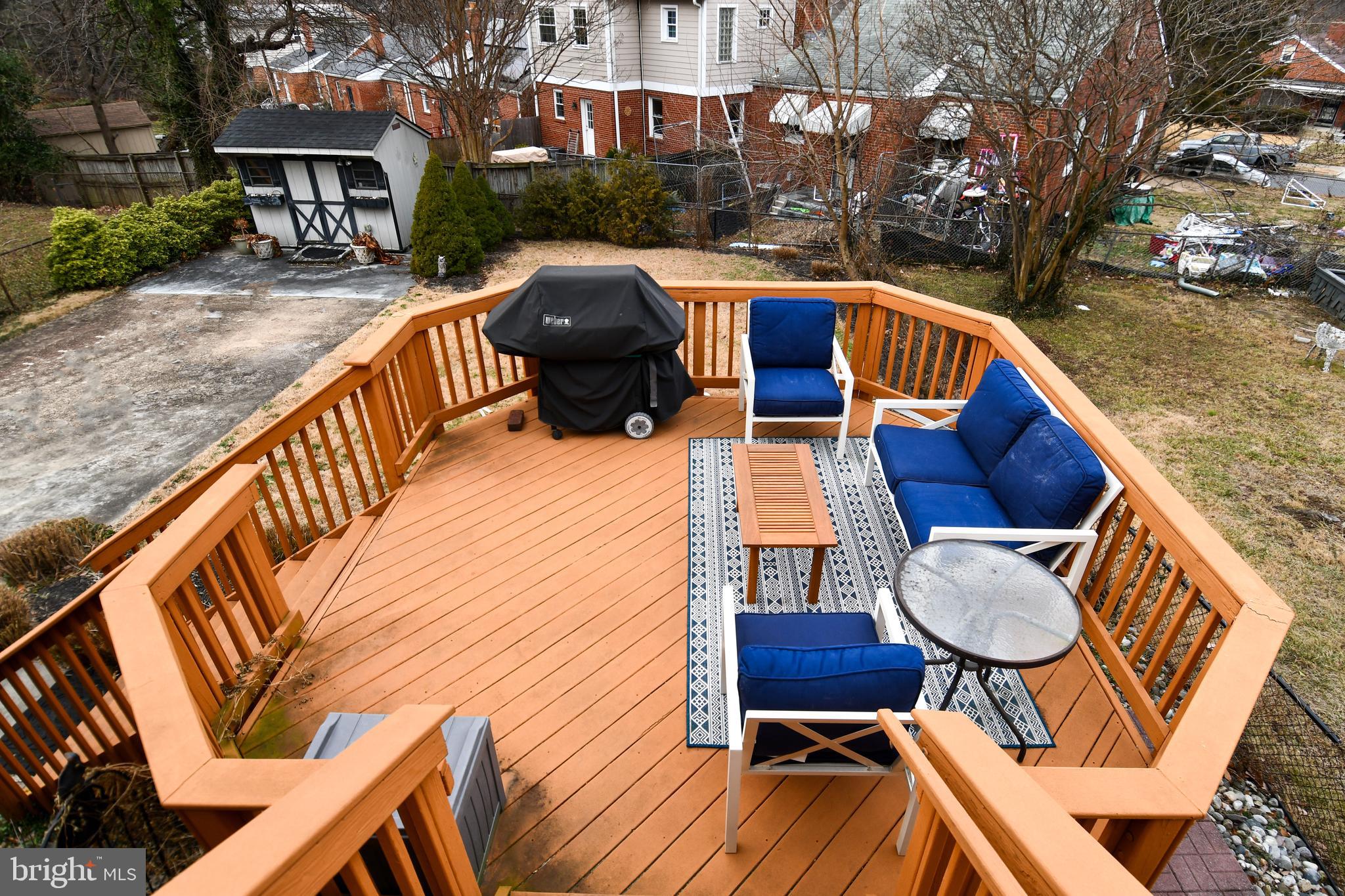 6208 Sligo Mill Road Northeast Washington, DC 20011 - Photo 43 of 50 a view of deck with patio table and chairs with wooden floor and fence