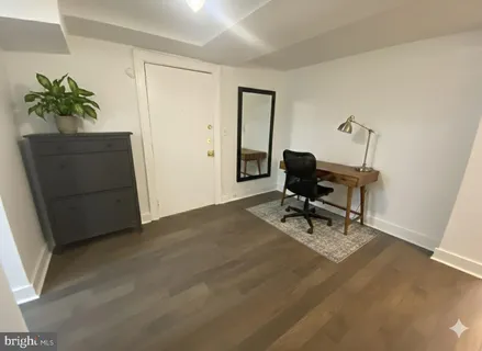a view of a workspace with furniture and a potted plant