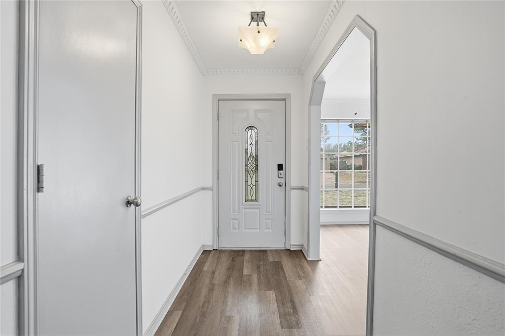 4612 Applewood Road Fort Worth, TX 76133 - Photo 17 of 39 Foyer with dark wood-style flooring and crown molding