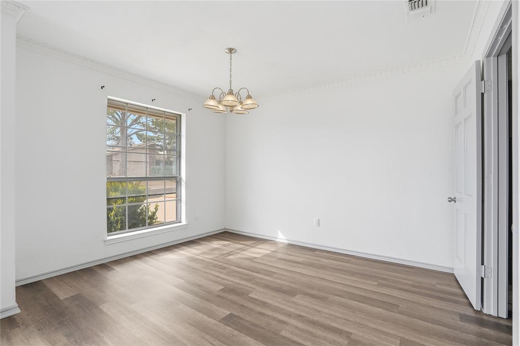 4612 Applewood Road Fort Worth, TX 76133 - Photo 20 of 39 Spare room with ornamental molding, light wood-style flooring, and a chandelier