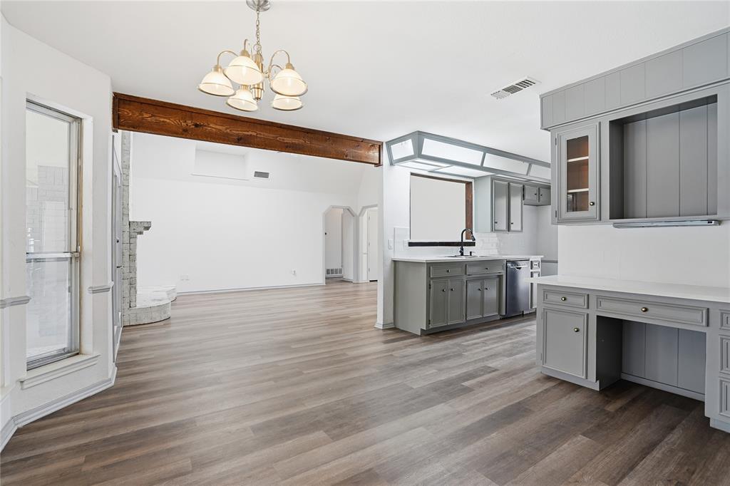 4612 Applewood Road Fort Worth, TX 76133 - Photo 25 of 39 Kitchen with gray cabinetry, arched walkways, decorative light fixtures, and dark wood-style flooring