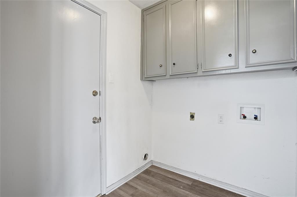 4612 Applewood Road Fort Worth, TX 76133 - Photo 26 of 39 Washroom with hookup for an electric dryer, dark wood finished floors, hookup for a washing machine, and cabinet space