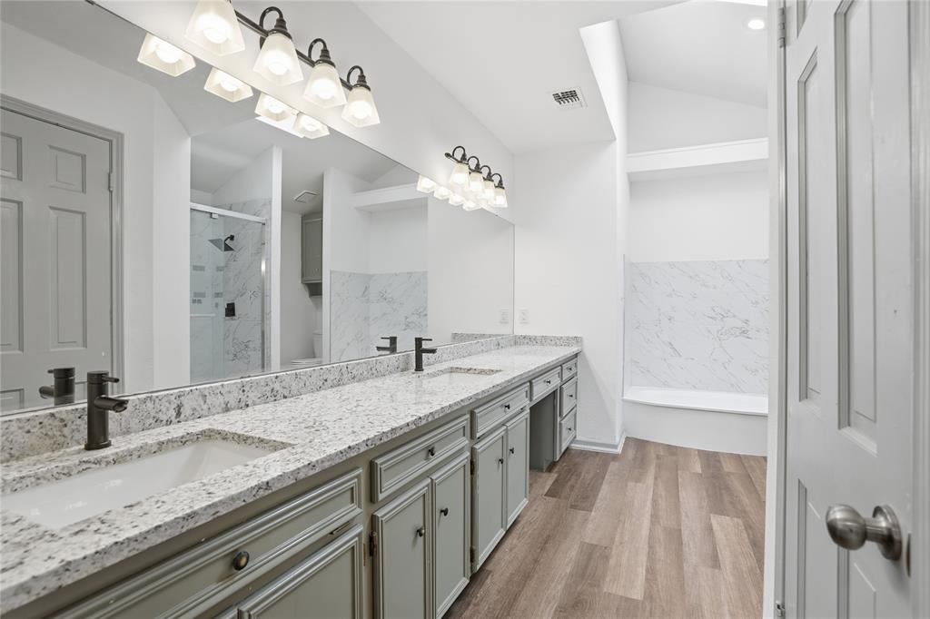 4612 Applewood Road Fort Worth, TX 76133 - Photo 31 of 39 Full bathroom featuring a marble finish shower, a bathtub, double vanity, and light wood-type flooring