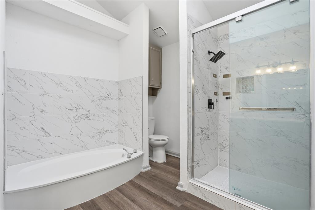 4612 Applewood Road Fort Worth, TX 76133 - Photo 32 of 39 Full bath with a marble finish shower, a garden tub, and dark wood-style floors