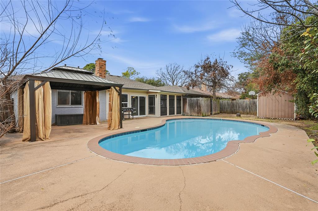 4612 Applewood Road Fort Worth, TX 76133 - Photo 35 of 39 View of swimming pool with a patio, a fenced backyard, a storage unit, a gazebo, and a sunroom