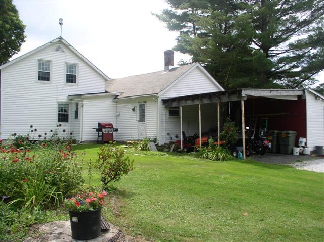 493 Main Road Stamford, VT 05352 - Photo 17 of 24 a front view of a house with a garden and porch