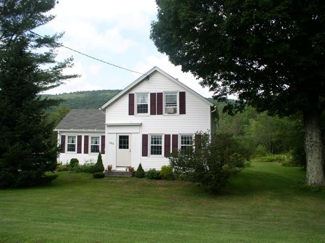 493 Main Road Stamford, VT 05352 - Photo 22 of 24 a front view of a house with garden