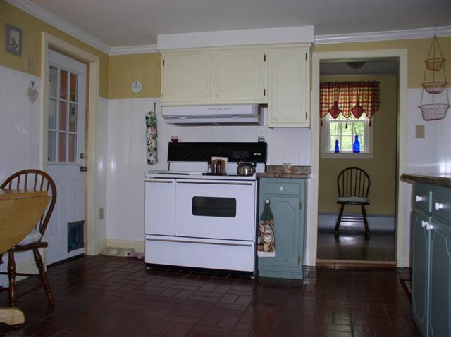 493 Main Road Stamford, VT 05352 - Photo 7 of 24 a kitchen with a stove and a dining table