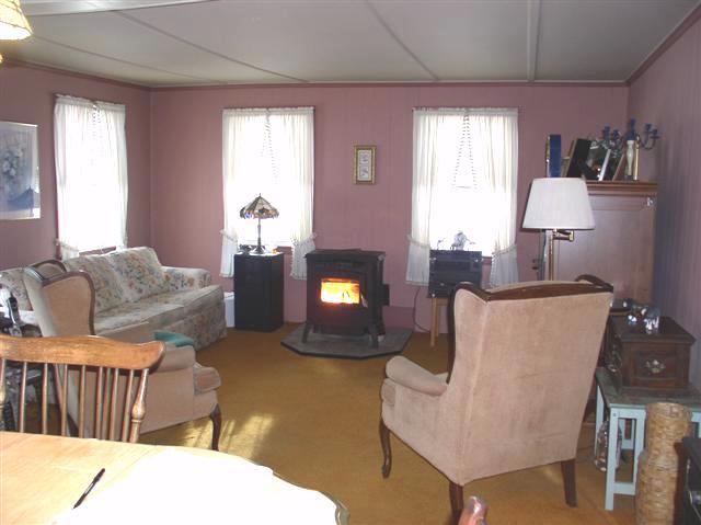 493 Main Road Stamford, VT 05352 - Photo 10 of 24 a living room with furniture and a fireplace