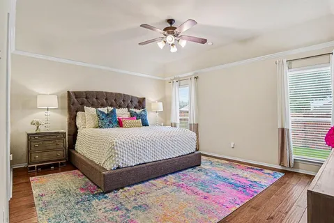a bedroom with a large bed and a chandelier