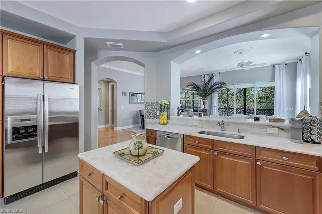 a kitchen with stainless steel appliances granite countertop a sink a microwave cabinets and wooden floor