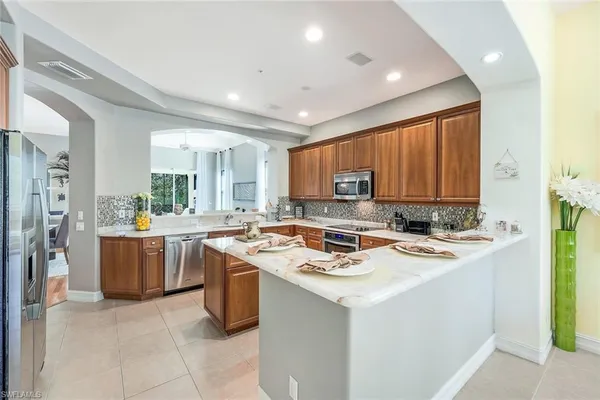 a kitchen with a stove a sink a refrigerator and a microwave