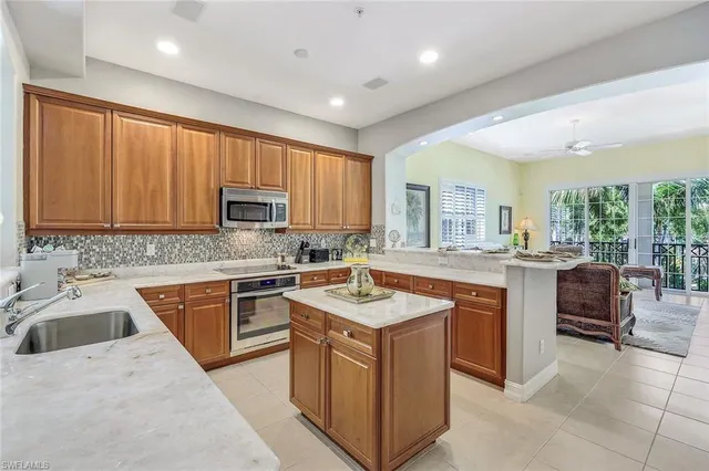 a kitchen with a sink stove top oven and refrigerator