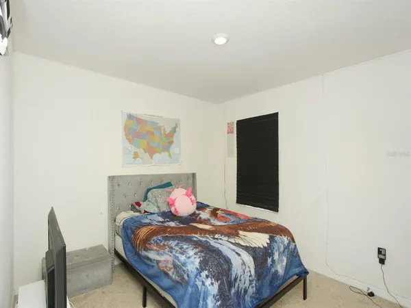 a bedroom with a bed and a table
