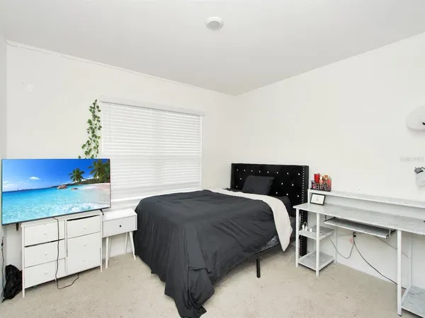 a bedroom with a bed and a dresser