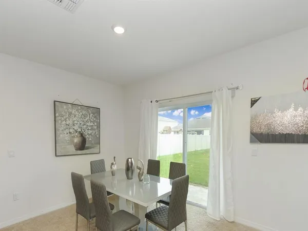 a dining room with furniture and window