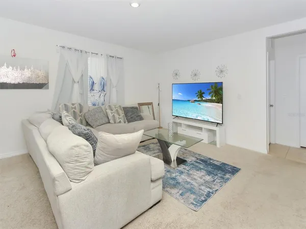 a living room with furniture and a rug