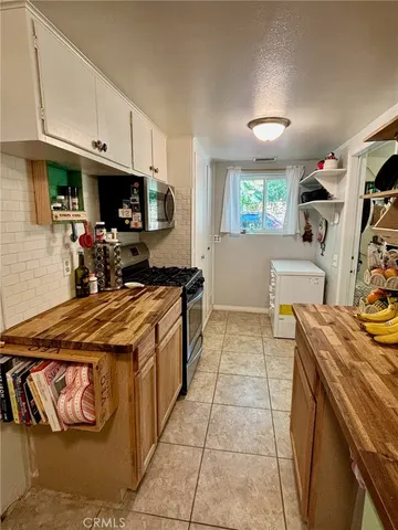 a kitchen that has a sink and a stove in it