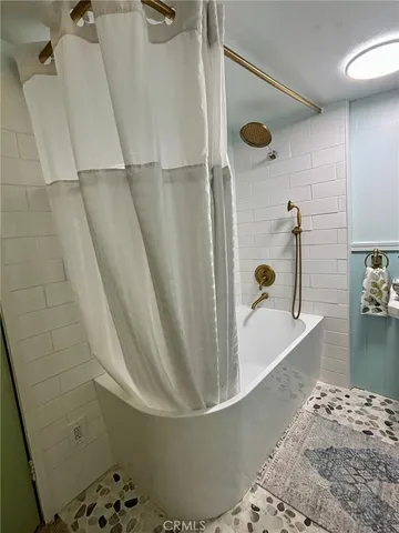 a bathroom with a bathtub and a shower