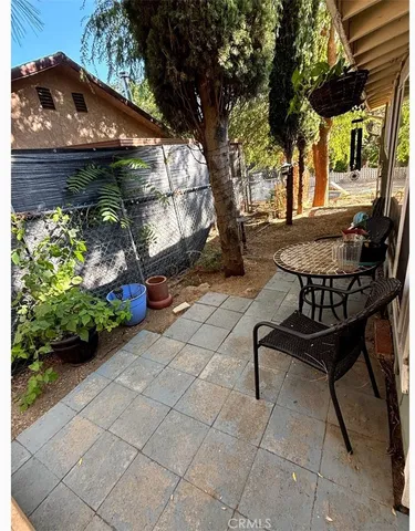 a view of a chairs and table in backyard